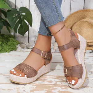 Elegant brown women's wedge sandals featuring buckle straps and a thick platform sole