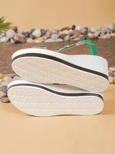Textured non-slip sole of green wedge sandals with size 37 mark