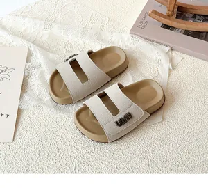 Close-up of children's forest-style breathable beige slides on textured background