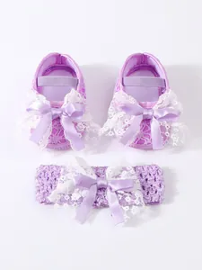 Detailed close-up view of purple baby shoes and lace headband set for newborn girls