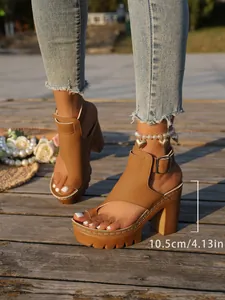 Detail view of tan platform sandals featuring a 10.5cm chunky high heel and buckle