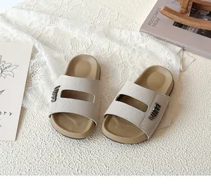 Macro view showing the texture and metal logo of children's khaki Birkenstock sandals