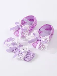 Detailed view of purple lace baby shoes and matching bow headband set.