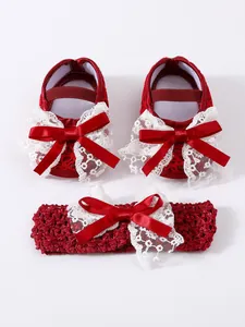 Detailed view of handmade red infant dress shoes and matching lace bow headband gift set