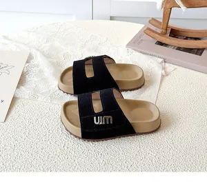 Detailed view of children's forest style black Birken slides with metal UIM logo