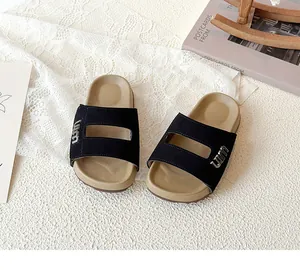 Detailed top view of black and beige forest style children's Birkenstock slides