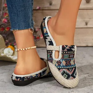 Ethno-Mules aus gewebtem Canvas mit geometrischem Muster und flachen Sohlen