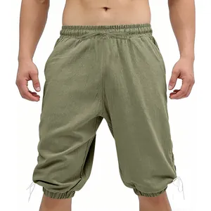Detail view of men's medieval Viking lace-up shorts in olive green cotton fabric