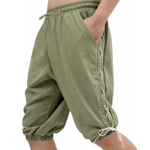 Detail view of men's olive green medieval Viking lace-up shorts with side pockets