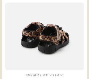Detailed back view of leopard print toddler sandals featuring black rubber anti-slip soles