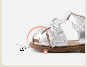 Close-up of silver baby walking sandals featuring a 15-degree toe spring and lace bow.