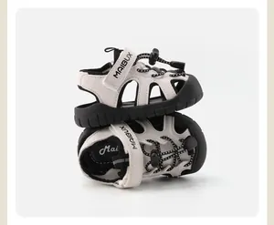 Detailed view of beige toddler sandals with black non-slip soles and MAIBUX branding