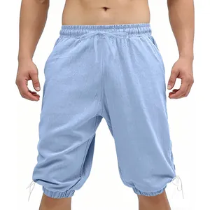 Detail view of light blue linen-like viking shorts with drawstring waist and cuffs