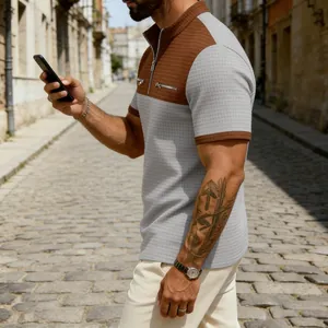 Close-up of textured waffle fabric and half-zip collar on men's color-block shirt