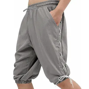 Macro detail of men's grey viking lace-up shorts featuring unique side drawstring design