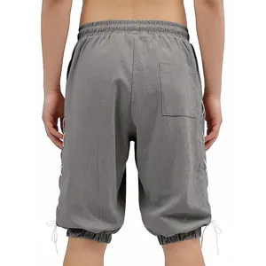 Close-up detail of men's vintage grey lace-up shorts featuring back pocket and side strings