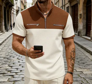 Detail view of men's color block waffle polo shirt with quarter zip and chest zippers.