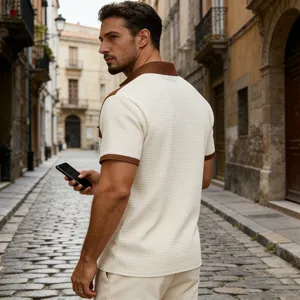 Detail of men's beige waffle knit polo shirt with brown accents and sleeve zipper pocket