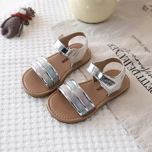 Detail view of silver metallic baby sandals with colorful glitter straps.