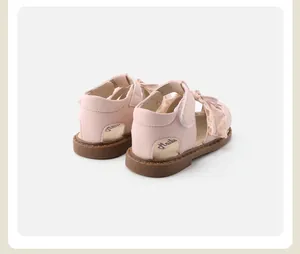 Detailed rear view of pink toddler walking shoes featuring delicate lace trim and soft soles