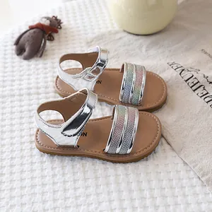 Detailed view of silver girls sandals with colorful glitter straps and soft soles