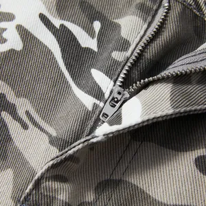 Close-up of the high-quality metallic zipper and camo fabric detail on men's cargo shorts