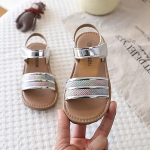 Detail of silver toddler girl sandals with colorful glitter straps and soft flat soles