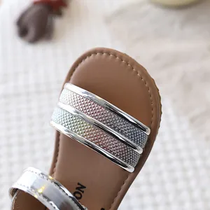 Close-up view showing the detailed metallic rainbow glitter strap of girls' soft sandals