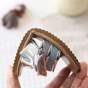 Close-up detail showing the flexible soft sole of silver girl sandals for toddler walking