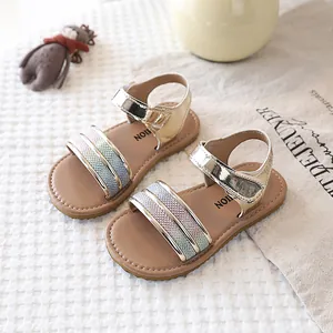 Detailed macro view of gold girls' sandals featuring sparkling gradient glitter straps