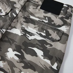 Close-up detail of camo cargo shorts featuring side pocket and waistband label