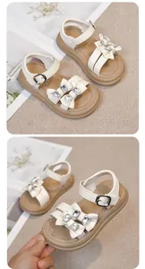 Close-up of white girls' sandals featuring rhinestone bows and durable rubber soles