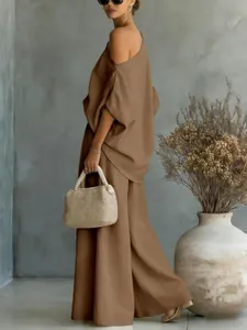 Full detail shot of women's elegant brown off-shoulder two-piece set with wide-leg pants