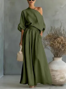 Detail view of olive green two-piece set featuring off-shoulder top and wide-leg pants