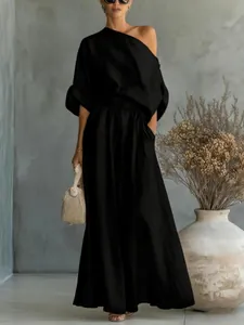Chic black one-shoulder top and maxi skirt two-piece set for a relaxed fashion look
