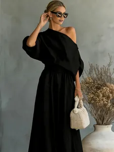 Black elegant two-piece outfit featuring a one-shoulder puff sleeve top and skirt