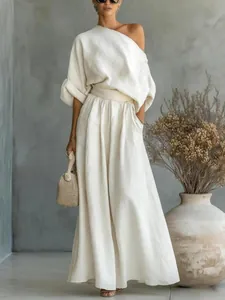 Full view of the outfit showing the elegant draping and wide-leg silhouette in a studio.