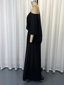 Side view detail of black off-shoulder loose top and wide-leg pants two-piece set