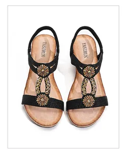 Bohemian wedge sandals featuring ethnic floral buckles and sparkling rhinestone details.