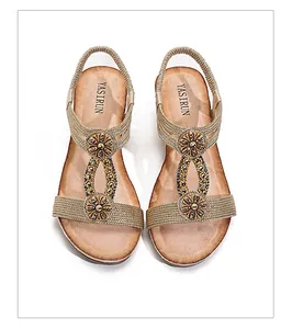 Bohemian wedge sandals with ethnic style braided straps and rhinestone flowers