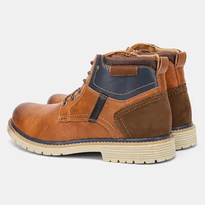 Detail view of men's vintage brown leather ankle boots with multi-textured panels.