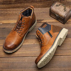 Detail view of vintage burnished brown leather ankle boots for men on wood background