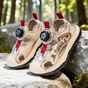 Beige boys closed-toe outdoor sports sandals with red accents and rotating lace dial