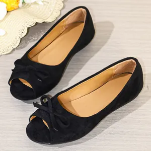 Elegant black peep-toe flats featuring a soft suede texture and a stylish bow detail.