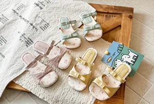 Detailed view of girls' bowknot sandals with floral print in three vibrant colors.