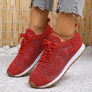 Close-up view of red breathable mesh low-top sneakers with floral pattern texture