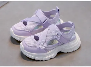 Close-up of girls' purple mesh sandals featuring floral pearls and a thick soft white sole.