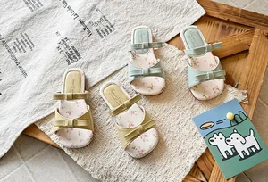 Detailed view of girls' bowknot sandals with floral print insoles in fresh colors