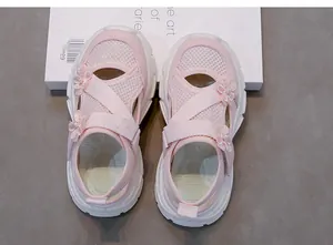 Top-down view of pink mesh girl sandals with delicate floral pearl accents