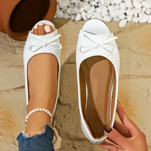 Macro view detail of elegant white flat fish-mouth shoes featuring a cute bow accent